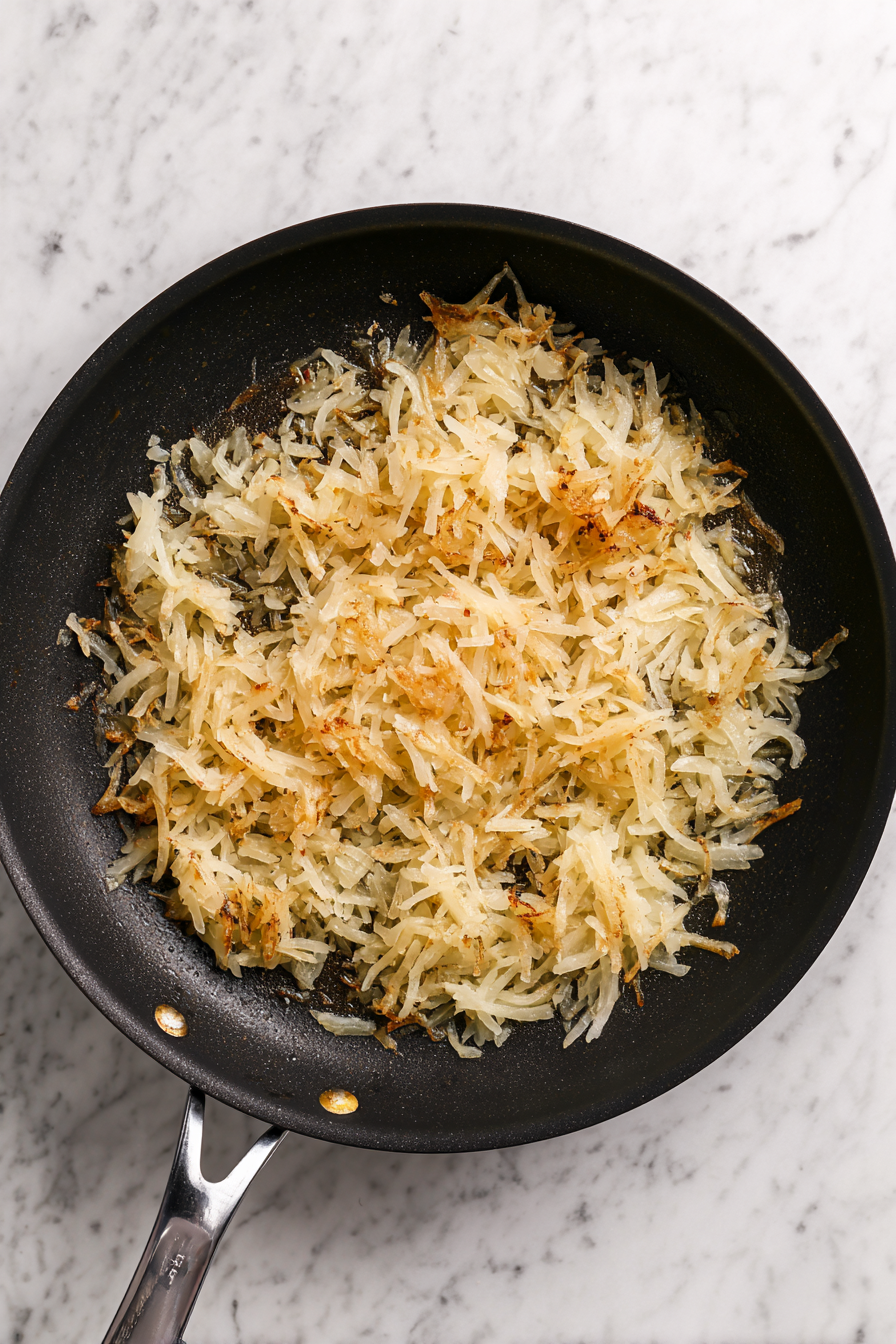 Add thawed hash browns, salt, and pepper. Cook until golden and crispy.