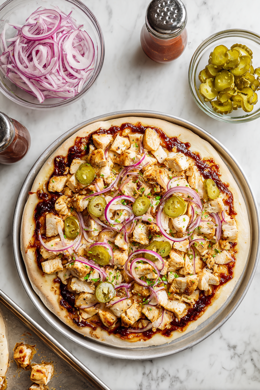 Top with cooked, cubed chicken, sliced pepperoncini, and chopped onions.