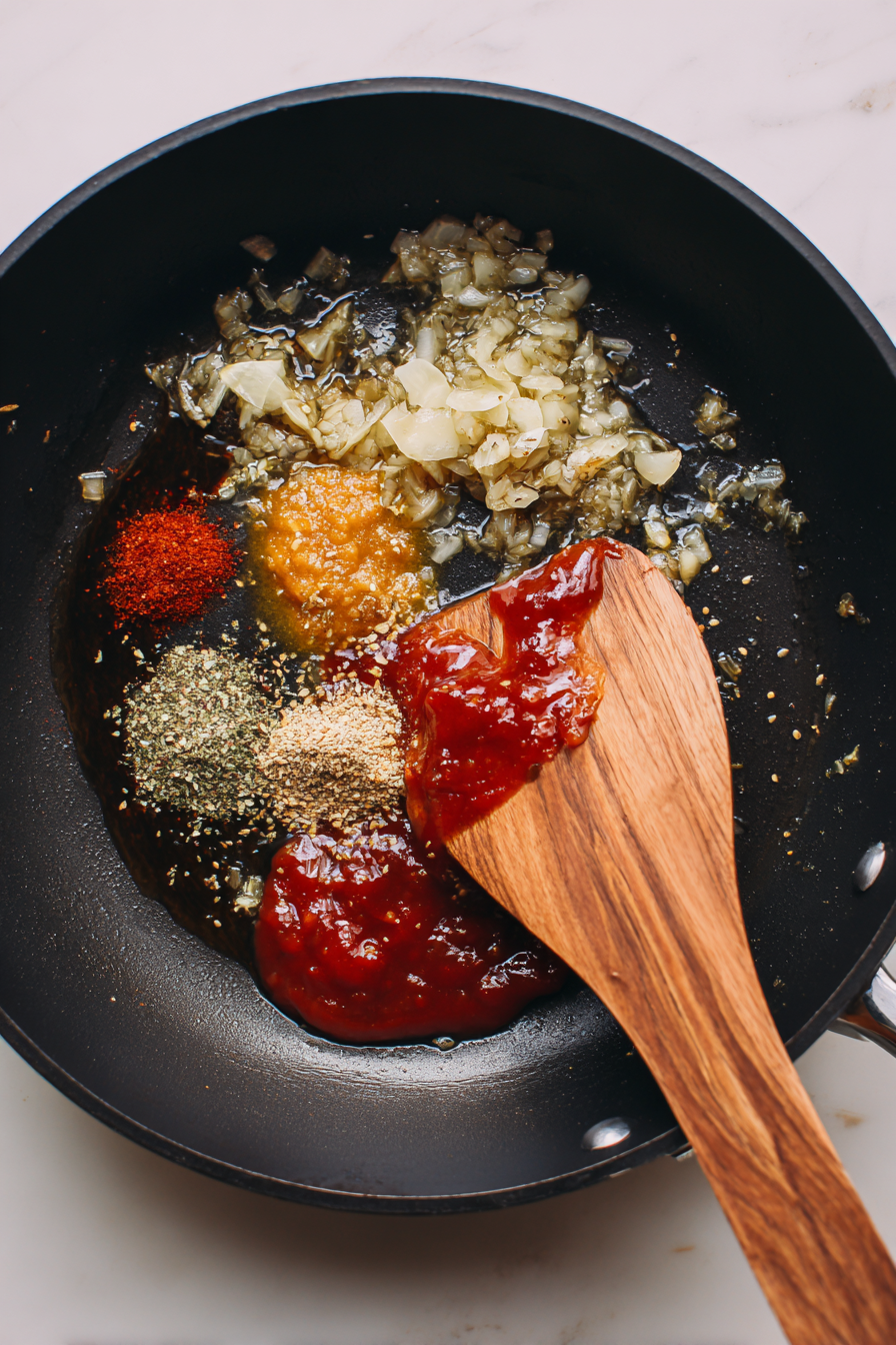 Add sriracha, tomato paste, Worcestershire sauce, fish broth, and remaining voodoo seasoning. Mix well.