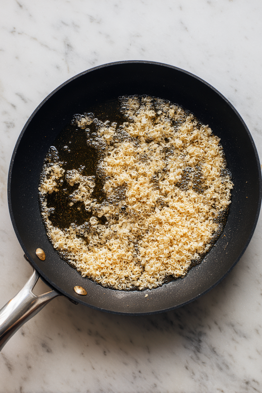 In the same pan, crisp rice noodles in hot oil for a few seconds until puffed.