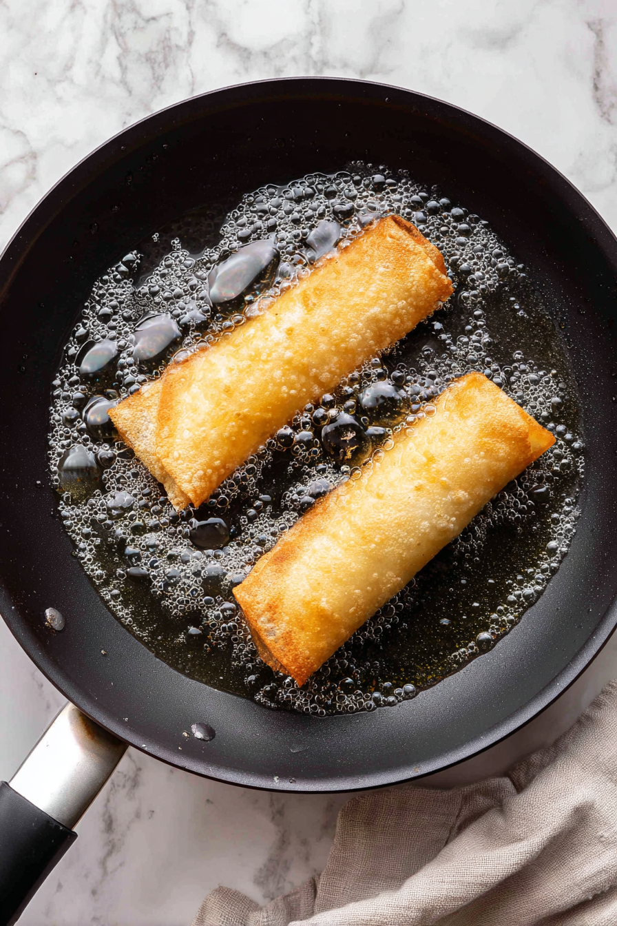 Fry wraps in hot oil until golden brown and crispy, turning once.