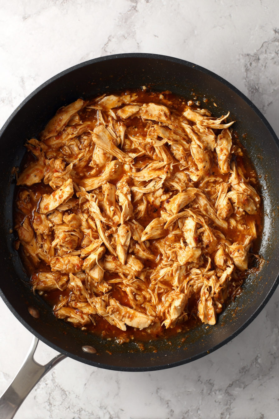 Return shredded chicken to the pan and mix into the sauce.
