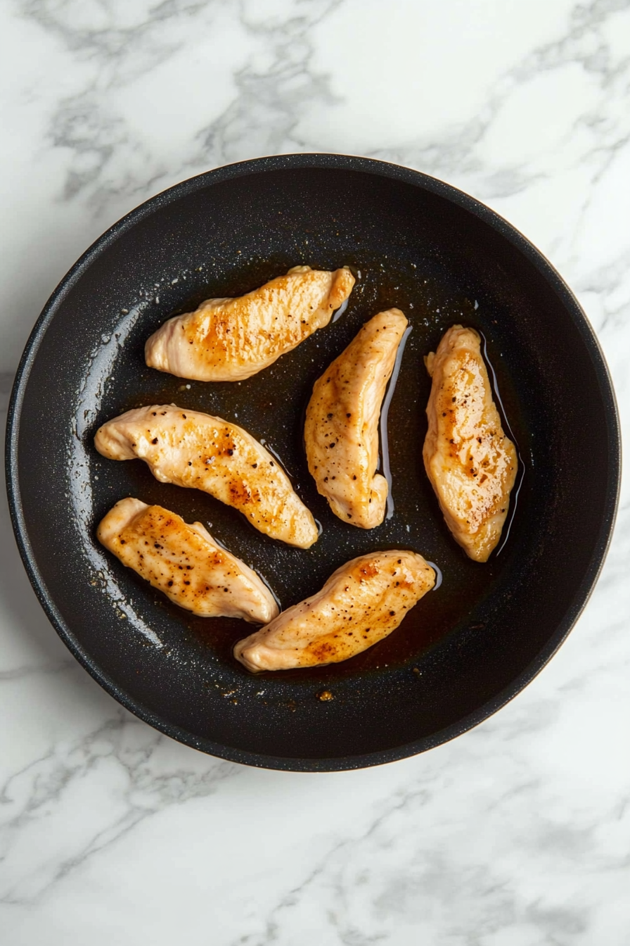Heat a skillet over medium-high heat and sear chicken tenderloins until cooked through and golden, about 5–6 minutes per side.
