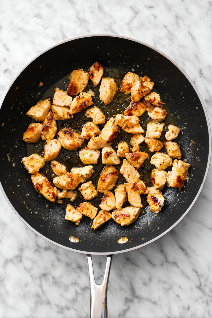 In a large skillet, heat olive oil over medium heat. Season chicken with salt and pepper, then cook until golden and fully cooked. Remove and set aside.