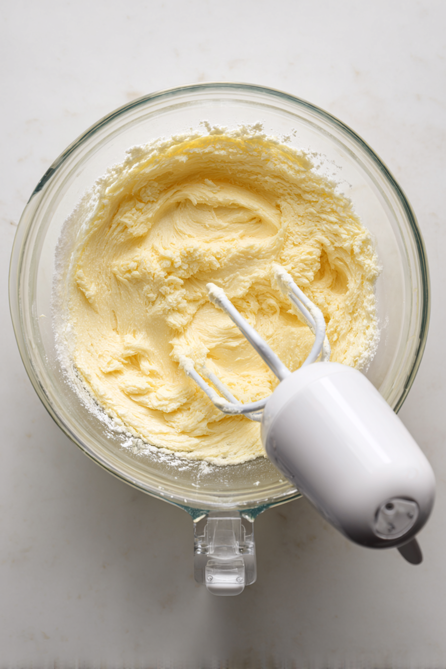 In another bowl, beat butter and sugar until light and fluffy. Add eggs and vanilla.