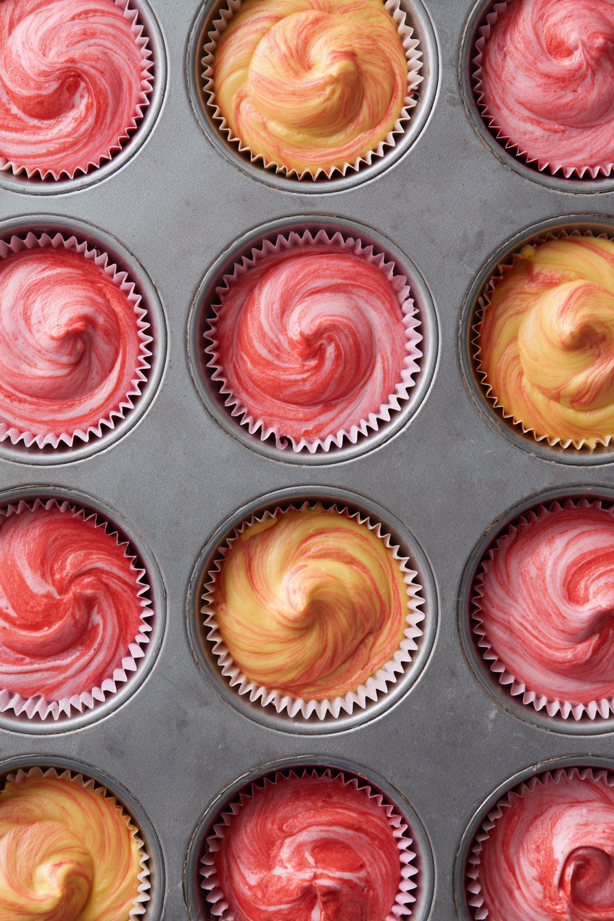 Spoon batters alternately into cupcake liners to create a marbled effect.