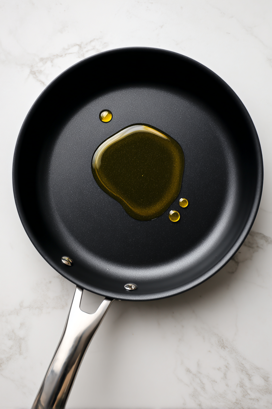 Heat canola oil in a skillet over medium heat.
