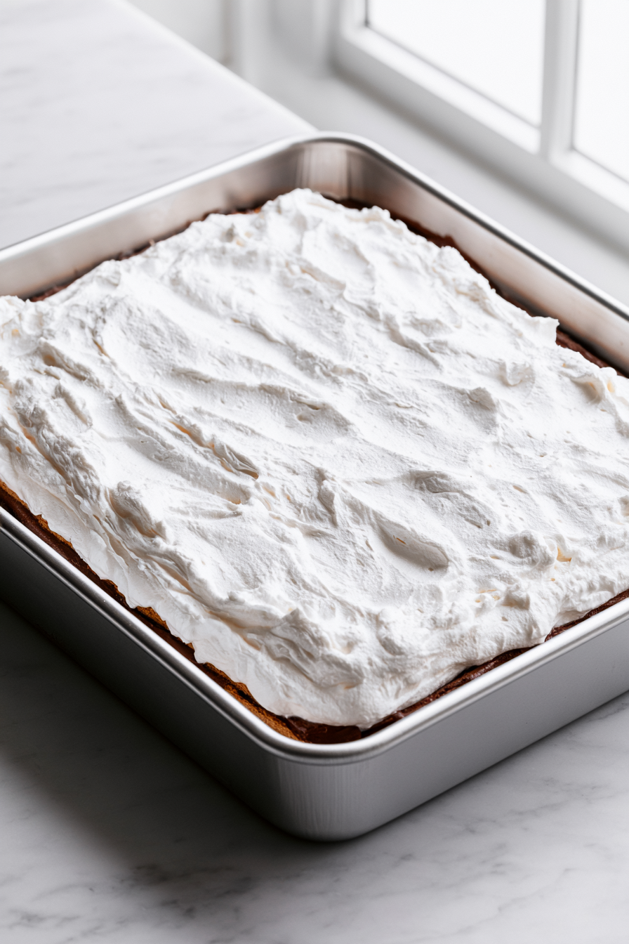 In a mixing bowl, beat together whipped topping and marshmallow fluff until smooth